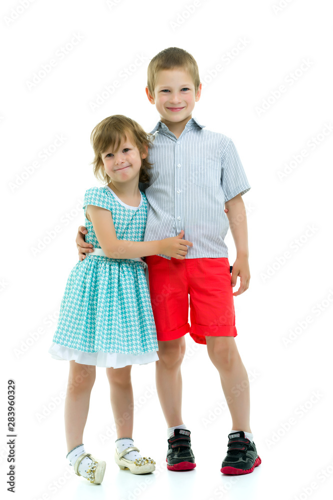 Brother and sister, boy and girl posing in the studio. Friendshi Brother and sister, boy and girl posing in the studio. Friendshi