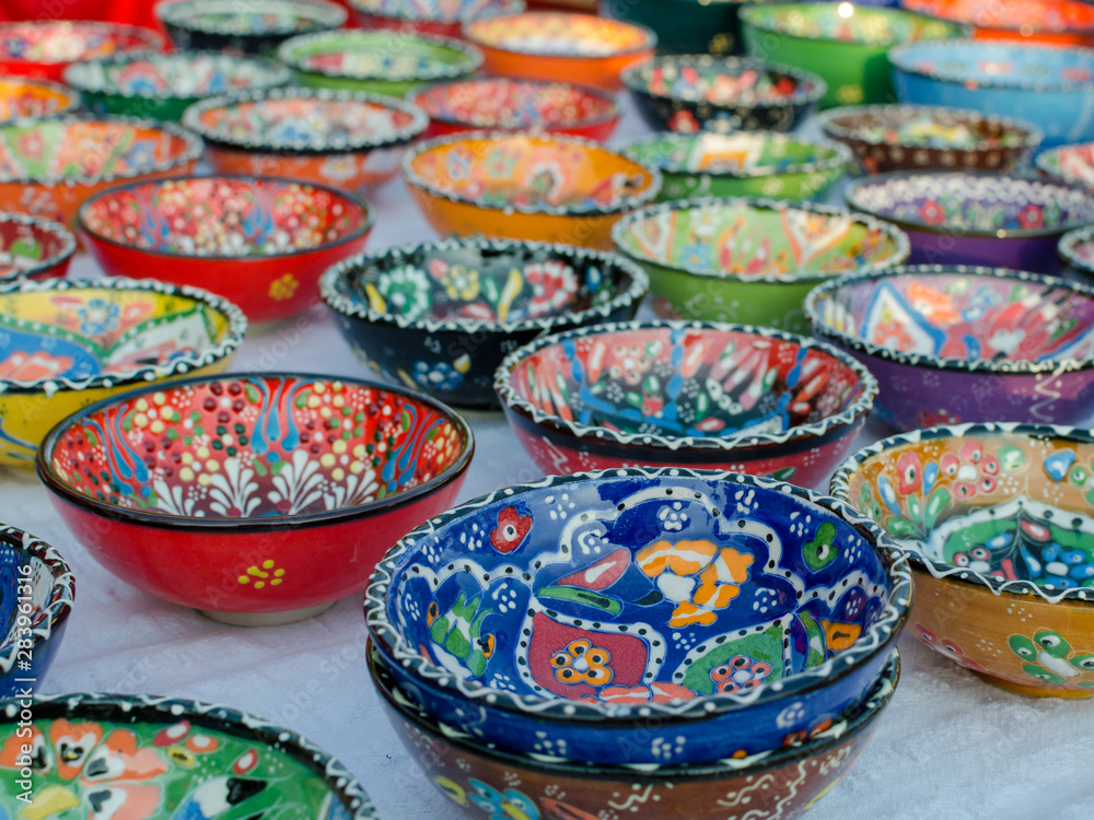 Turkish handmade colourful ceramic plates and bowls. Close up.