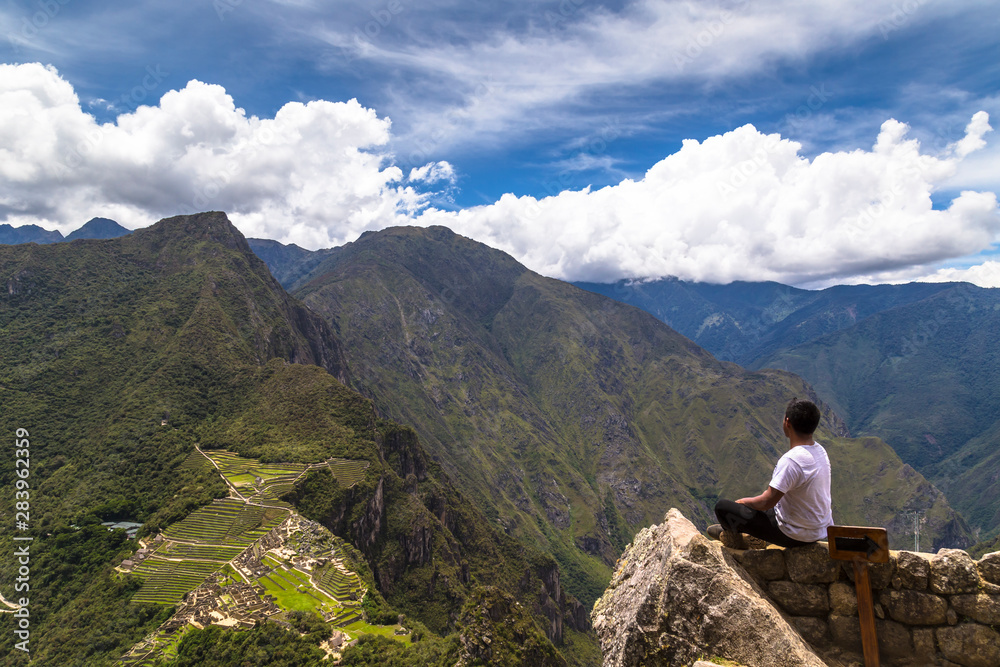 Traveller at the Lost city of the Incas, Machu Picchu,Peru on top of the mountain, with the view panoramic.