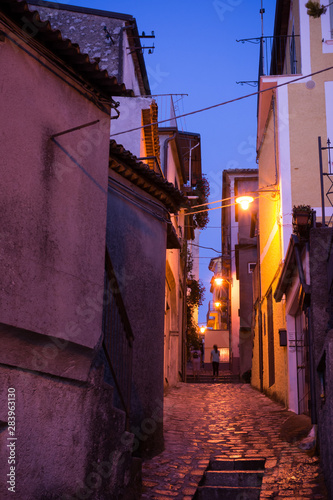 Narrow Alley Lightened at Blue Hour in the CIty of Rotonda, in the South of Italy