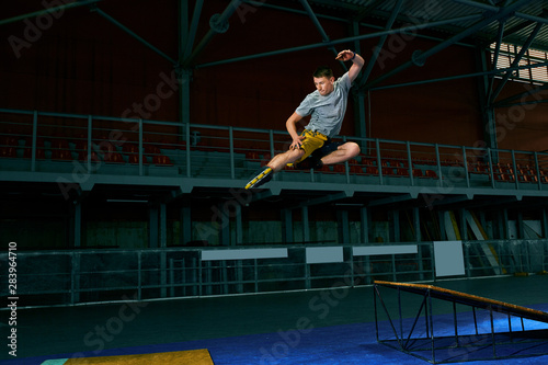 The man performs a trick. Jump. Indoor training