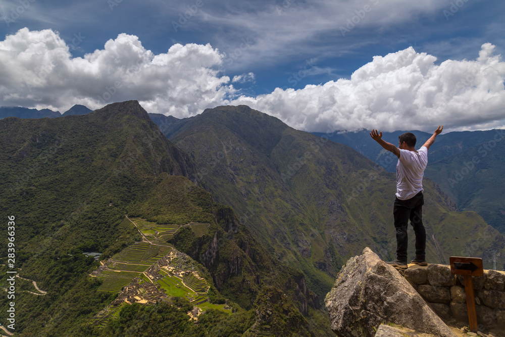 Traveller at the Lost city of the Incas, Machu Picchu,Peru on top of the mountain, with the view panoramic.