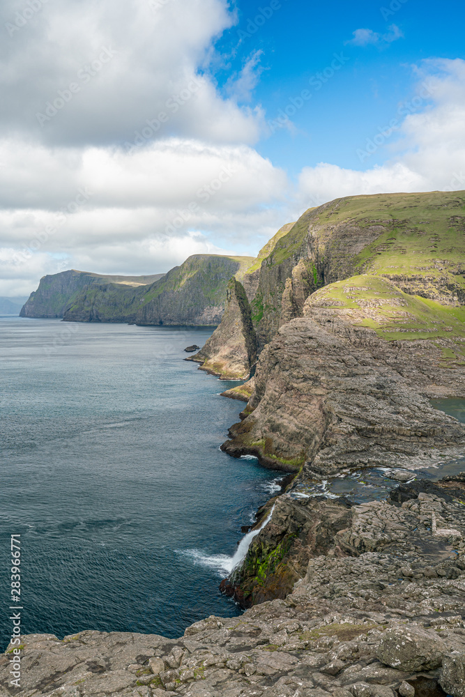 Bosdalafossur waterfall on Vagar island coastline, Faroe Islands