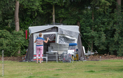woman installing the a roof caravan on a camping