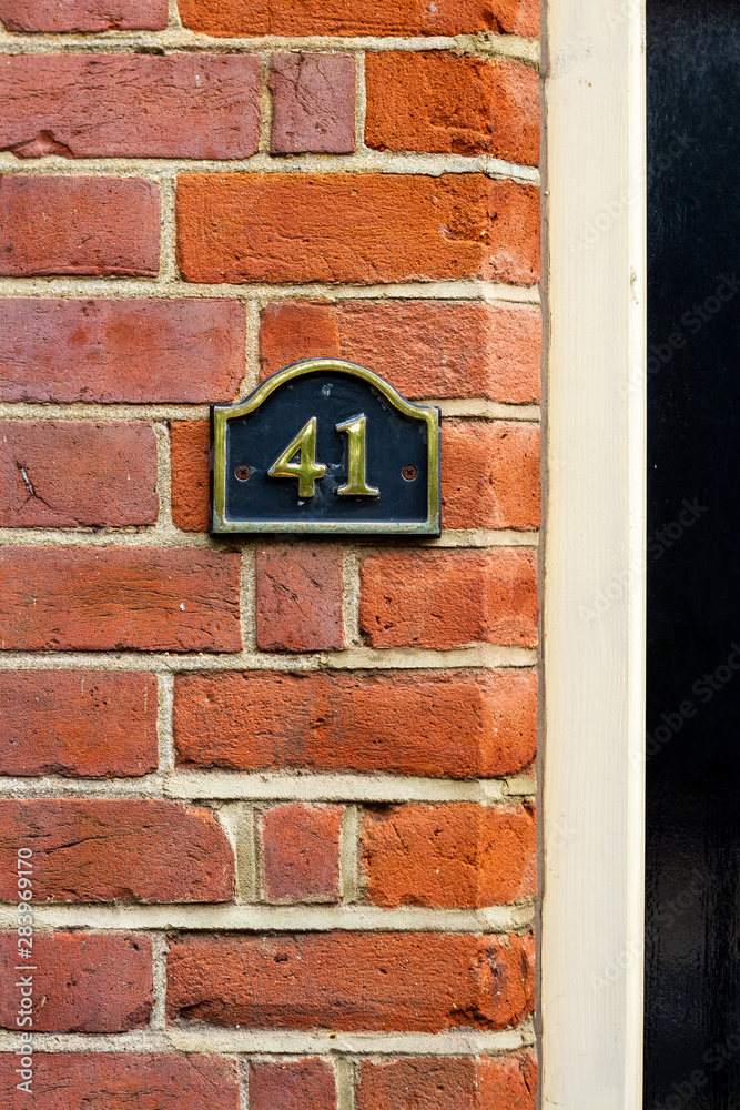 House number 41 on a red brick wall