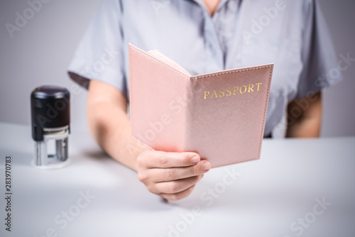 Immigration and passport control at the airport. woman border control officer puts a stamp in the passport. Concept