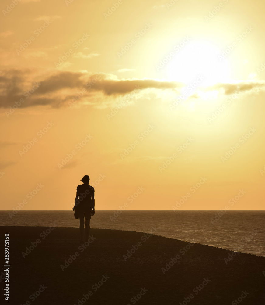 Girl walking at sunset