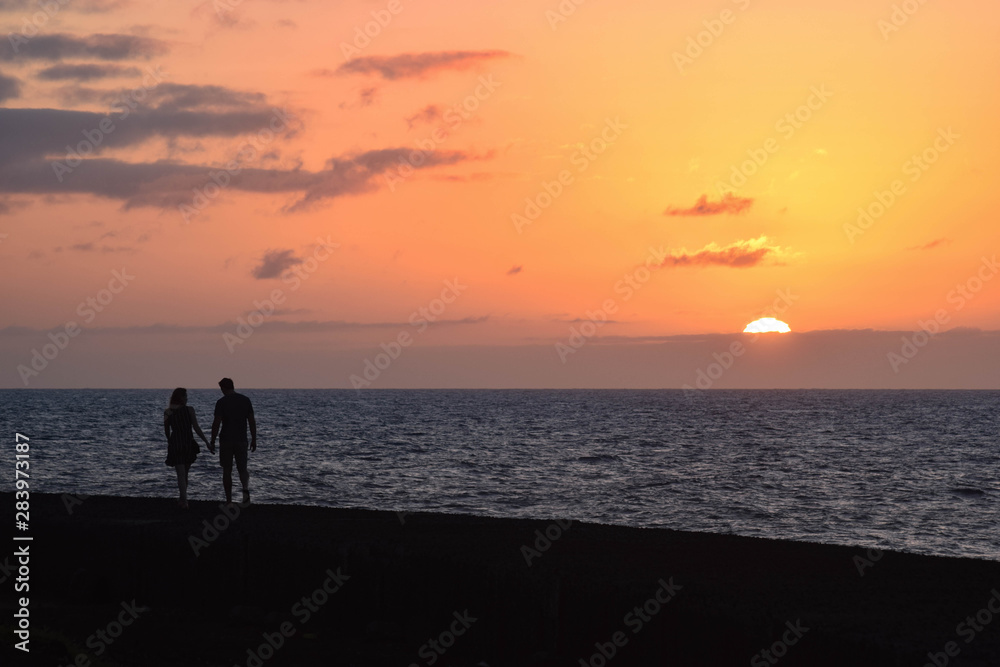 Couple walking at sunset