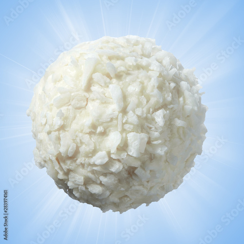 Sweets made of white creamy chocolate in coconut on a soft blue background. Full sharpness. photo