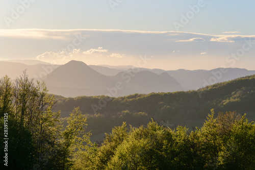 Apennines mountain landscape seen from the "Piana degli Ossi" at sunset time, a wide valley near Firenzuola, on the path of the Gods road or "la via degli Dei", in Italy