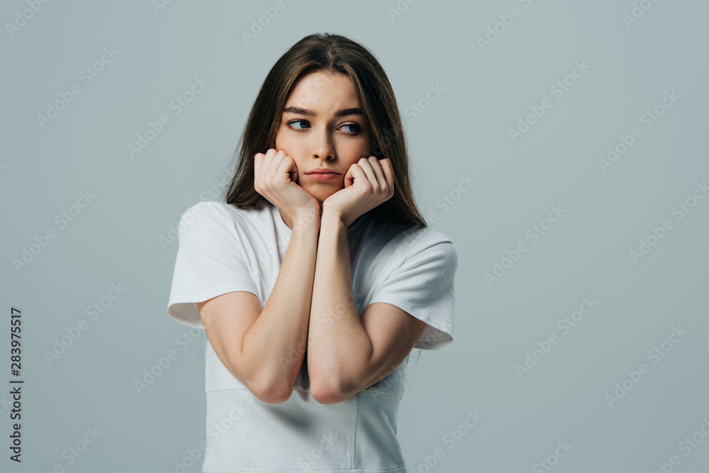 beautiful upset girl with hands near face looking away isolated on grey beautiful upset girl with hands near face looking away isolated on grey