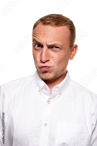 Handsome young blond man in a white shirt, isolated on a white background