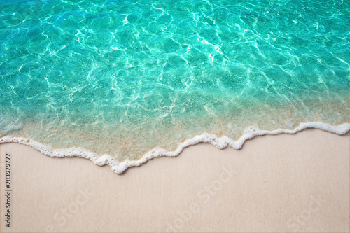 Soft blue ocean wave or clear sea on clean sandy beach summer concept