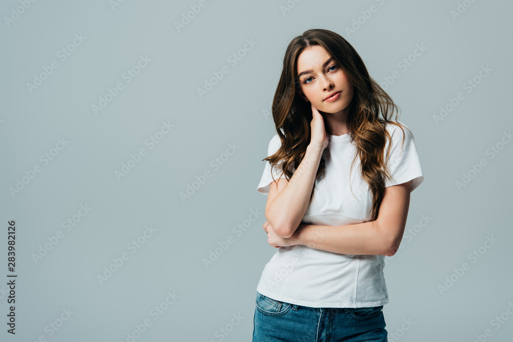 beautiful girl in white t-shirt looking at camera isolated on grey beautiful girl in white t-shirt looking at camera isolated on grey