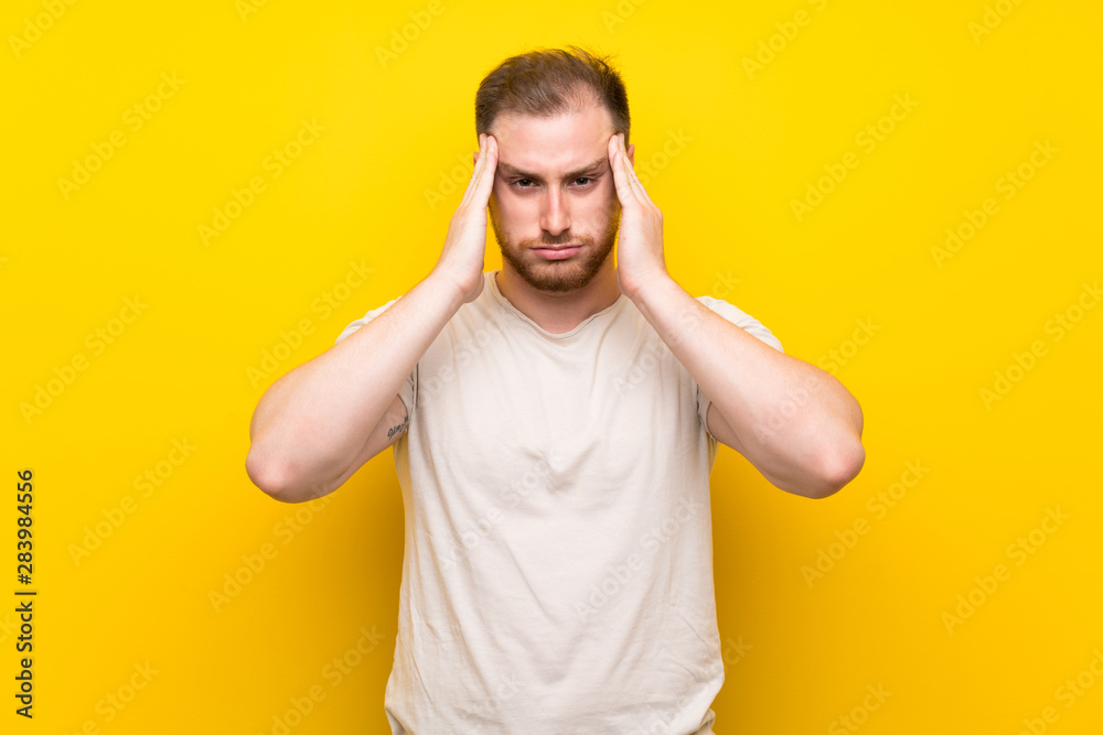 Handsome man over yellow background unhappy and frustrated with something. Negative facial expression Handsome man over yellow background unhappy and frustrated with something. Negative facial expression