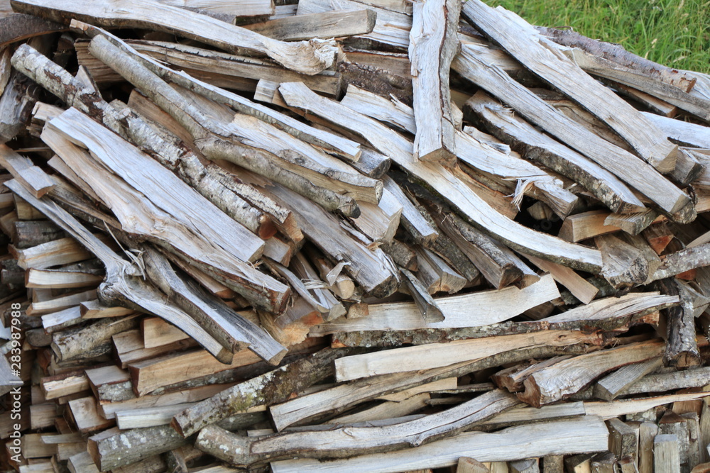 Firewood dry firewood in a pile for furnace kindling. Rustic background of logs Firewood dry firewood in a pile for furnace kindling. Rustic background of logs