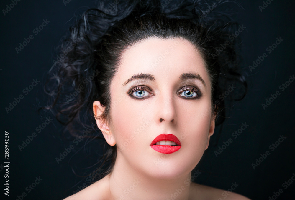 Young attractive woman with long black hair on dark background Young attractive woman with long black hair on dark background