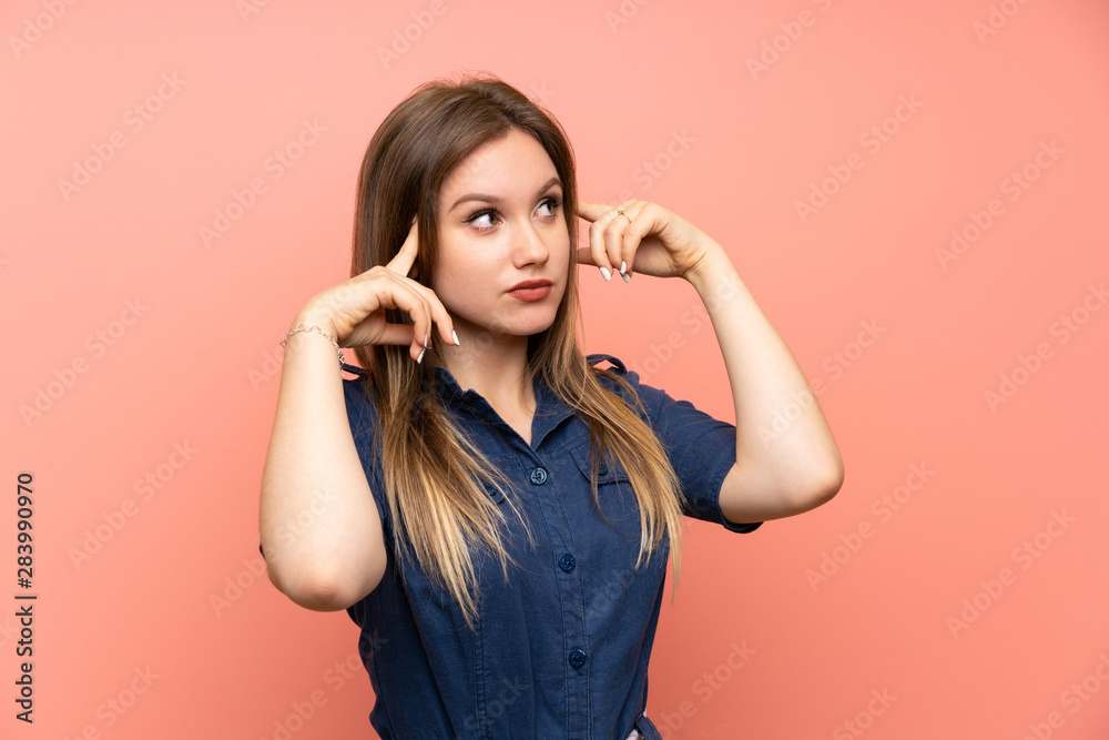 Teenager girl over isolated pink background having doubts and thinking Teenager girl over isolated pink background having doubts and thinking