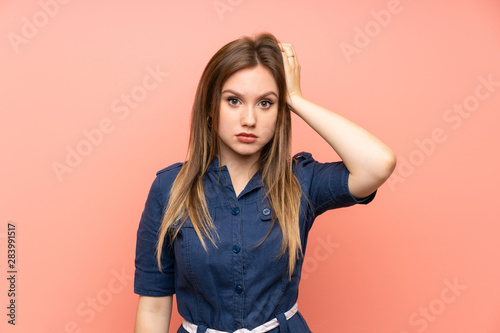 Teenager girl over isolated pink background with an expression of frustration and not understanding