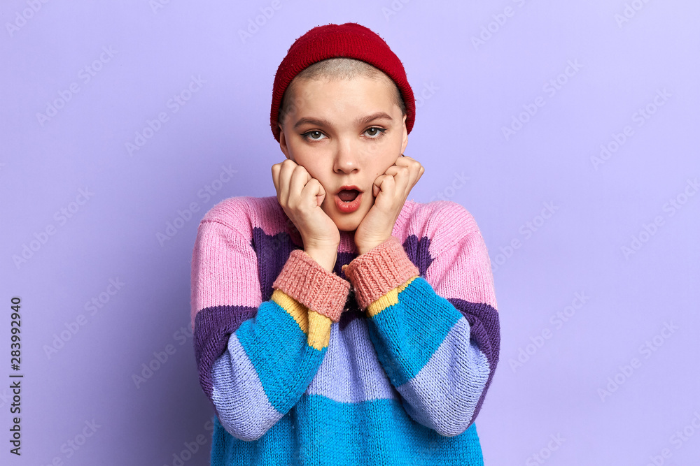Surprised beautiful cool young woman holds cheeks by hand, being surprised with news. close up photo. facial expression. Surprised beautiful cool young woman holds cheeks by hand, being surprised with news. close up photo. facial expression.