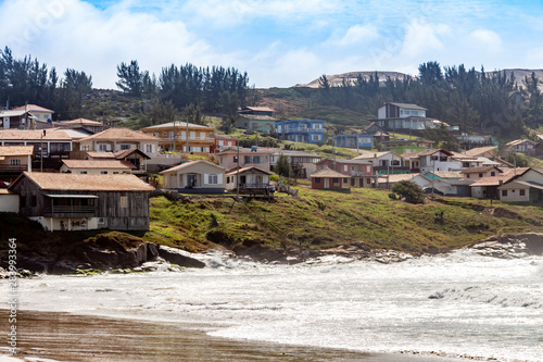 Village houses on top of a green hill in a beach