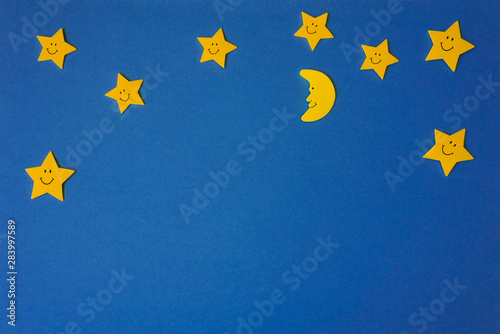 Vászonkép Crescent moon and yellow stars against the blue night sky
