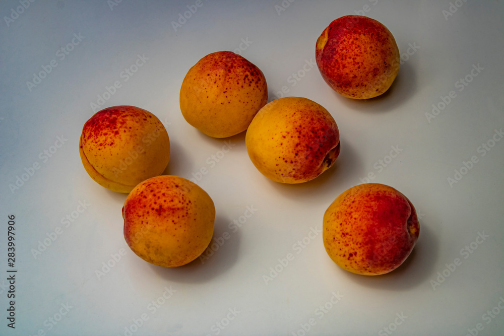 Ripe apricots on white background and in plate Ripe apricots on white background and in plate