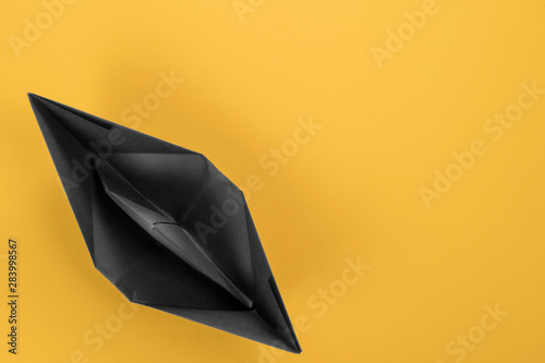 Black paper boat top view o...