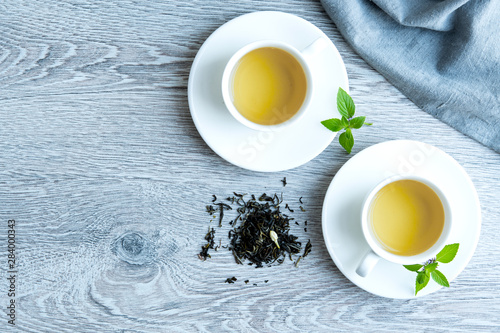 two cups of green tea on a gray background