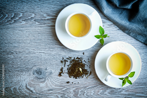 two cups of green tea on a gray background