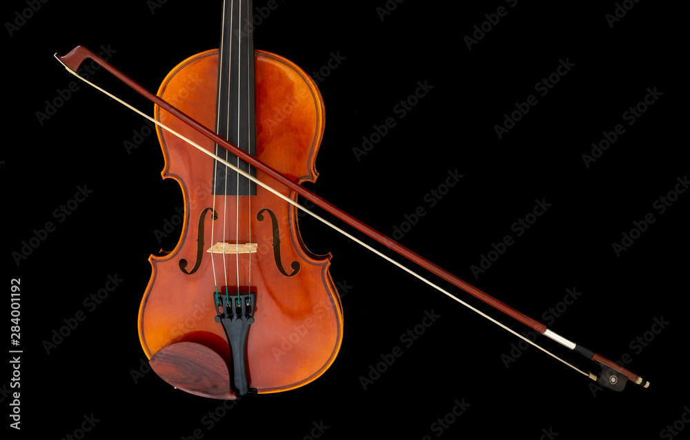 Child's violin with bow isolated on black background Child's violin with bow isolated on black background