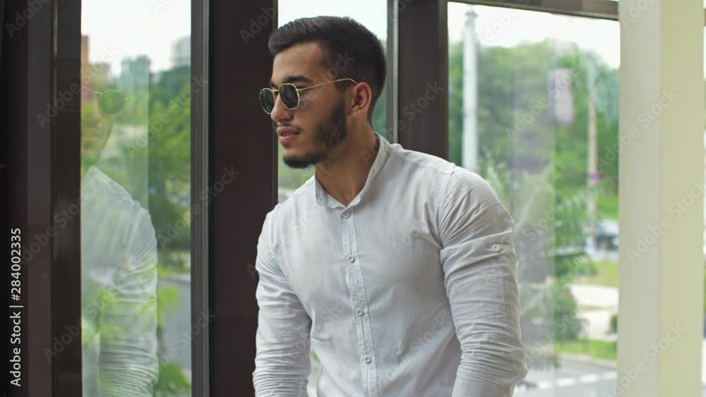 Young businessman look through the window Young businessman look through the window