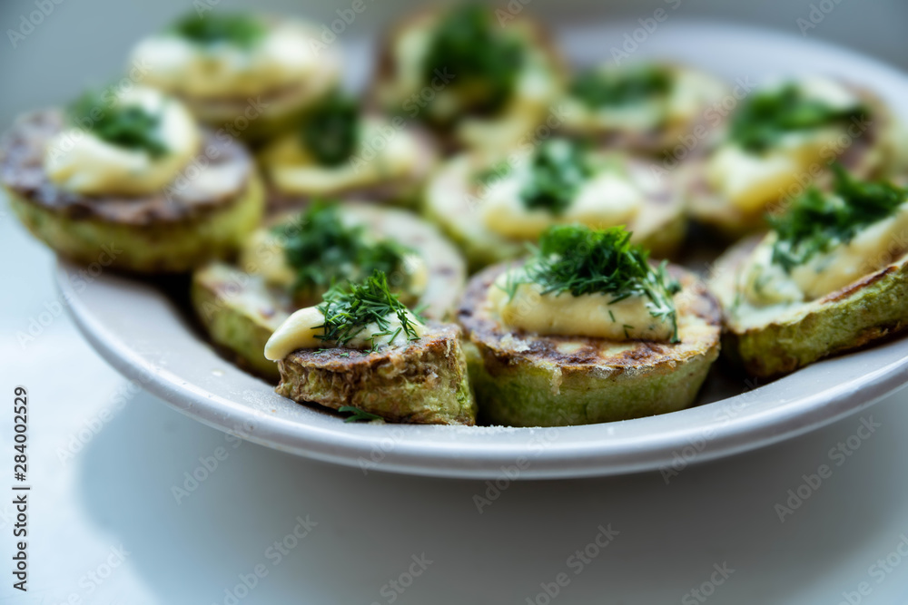 homemade zucchini fried with mayonnaise. On a white background homemade zucchini fried with mayonnaise. On a white background