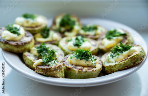 homemade zucchini fried with mayonnaise. On a white background