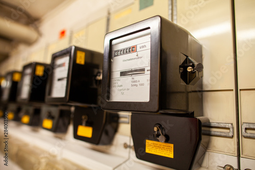 A lot of electric meter hangs in basement of a house
