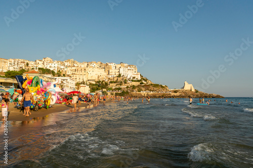 Fototapeta Naklejka Na Ścianę i Meble -  Editorial photo, August 12, 2019, Sperlonga, Italy, view on old town Sperlonga and clowded beach during August holidays in Lazio, Italy