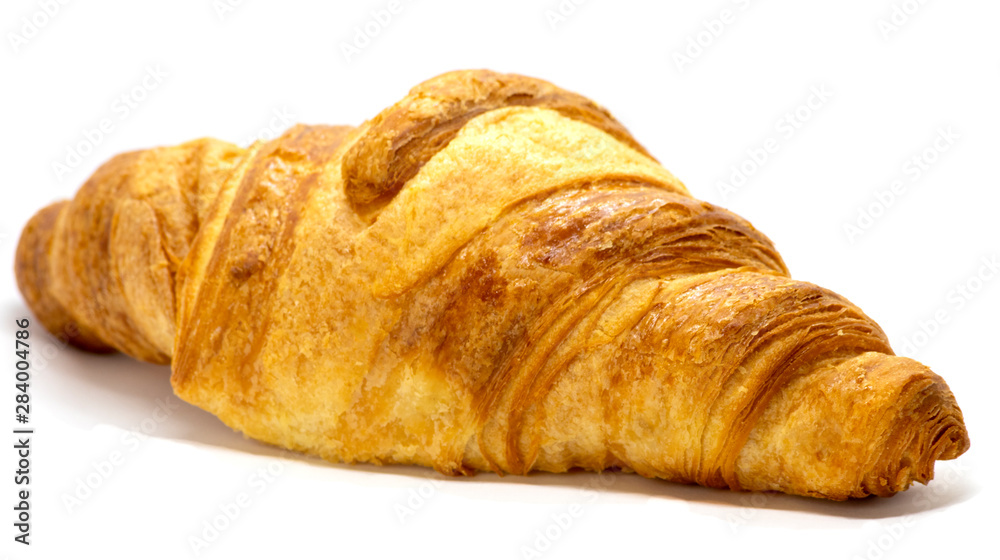 Freshly baked croissant with flaky texture on white background. 