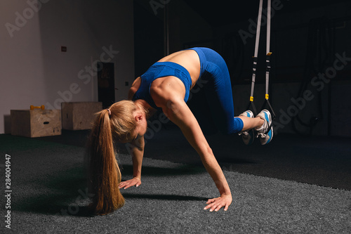 strong girl trying to lift her body while leaning on the floor. full length photo.flexibility photo