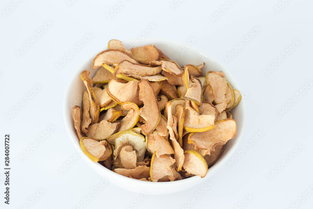 Apple quince chips in a white bowl isolated Apple quince chips in a white bowl isolated