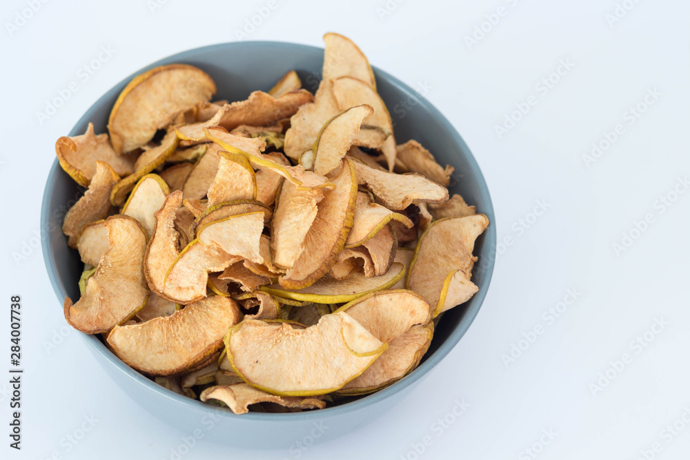 Apple quince chips in a grey bowl isolated healthy food Apple quince chips in a grey bowl isolated healthy food