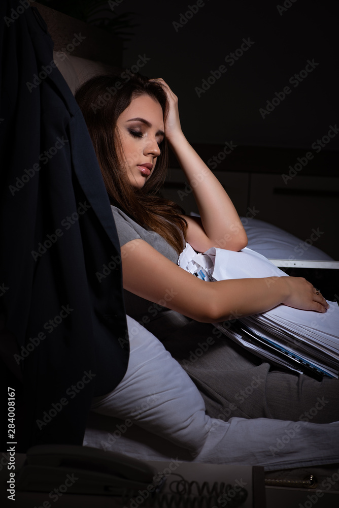 Tired businesswoman working overtime at home at night Tired businesswoman working overtime at home at night