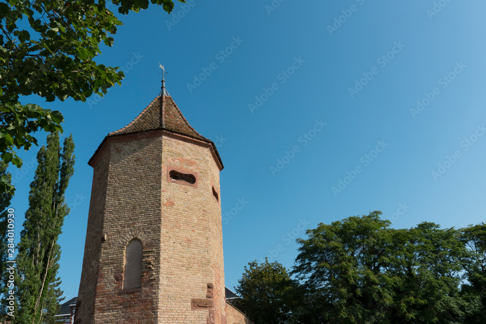 Tower and city wall in Haguenau, France. Blue sky, space for text