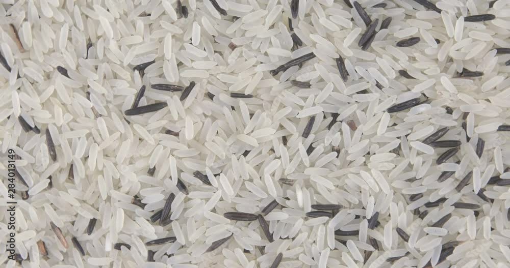 Rotating close up of a pile of raw rice Rotating close up of a pile of raw rice