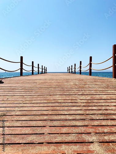 Wooden Pier on The Clear Sea with Non-Cloud Sunny Weather on the Beach © Mochatouch