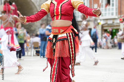 Woman dancing and wearing one of the traditional folk costume from Sri Lanka.