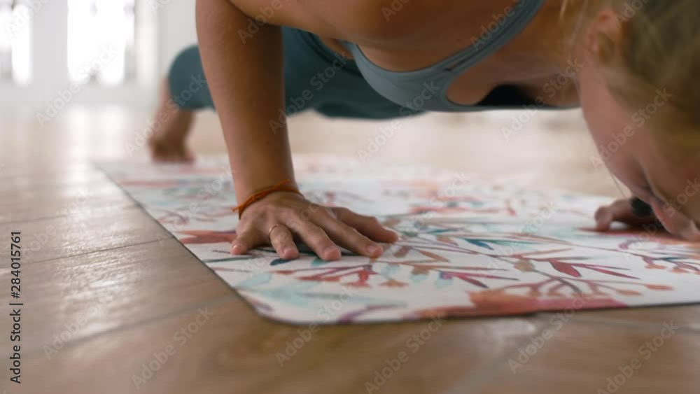 Zoom in shot of young athletic woman doing exercises on yoga mat Zoom in shot of young athletic woman doing exercises on yoga mat