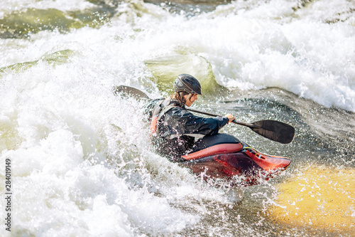 Guy in kayak sails mountain river. Whitewater kayaking, extreme sport rafting © Parilov