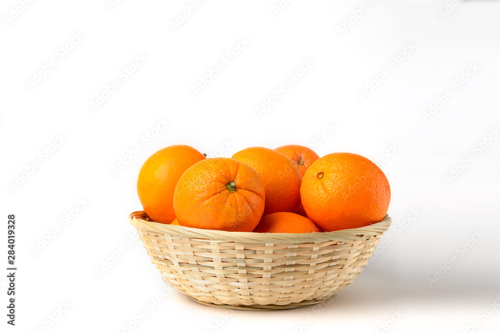 Fresh juicy oranges in wooden basket on white background Fresh juicy oranges in wooden basket on white background
