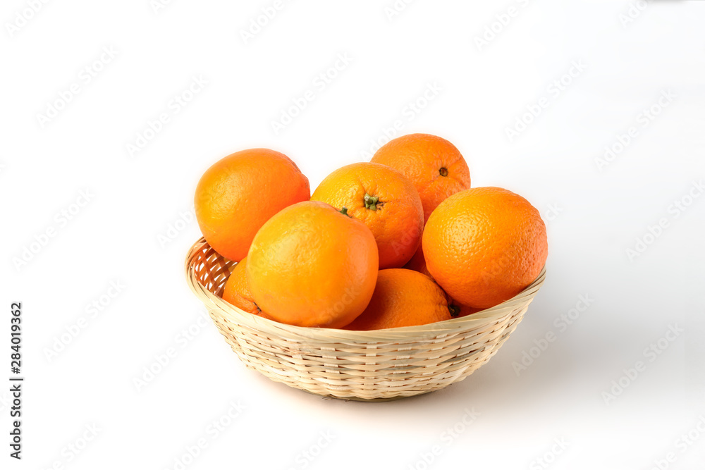 Fresh juicy oranges in wooden basket on white background Fresh juicy oranges in wooden basket on white background