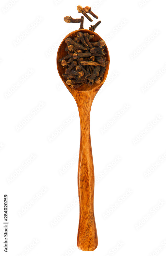Carnation in a wooden spoon on isolate. View from above. Seasoning in a wooden spoon. Spices on isolate. Carnation in a wooden spoon on isolate. View from above. Seasoning in a wooden spoon. Spices on isolate.